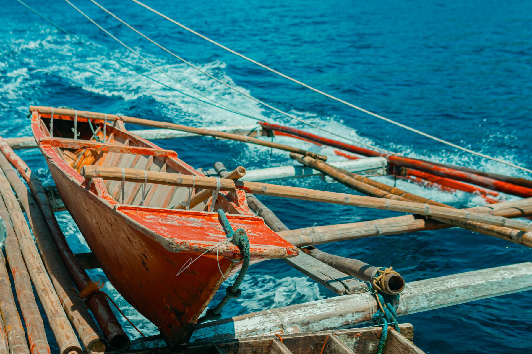Traditional wooden fishing canoe floating on a calm blue sea