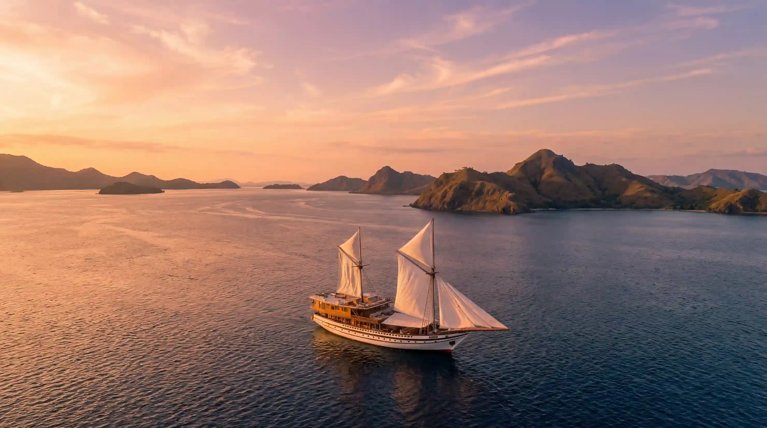 Phinisi schooner under sail over turquoise seas
